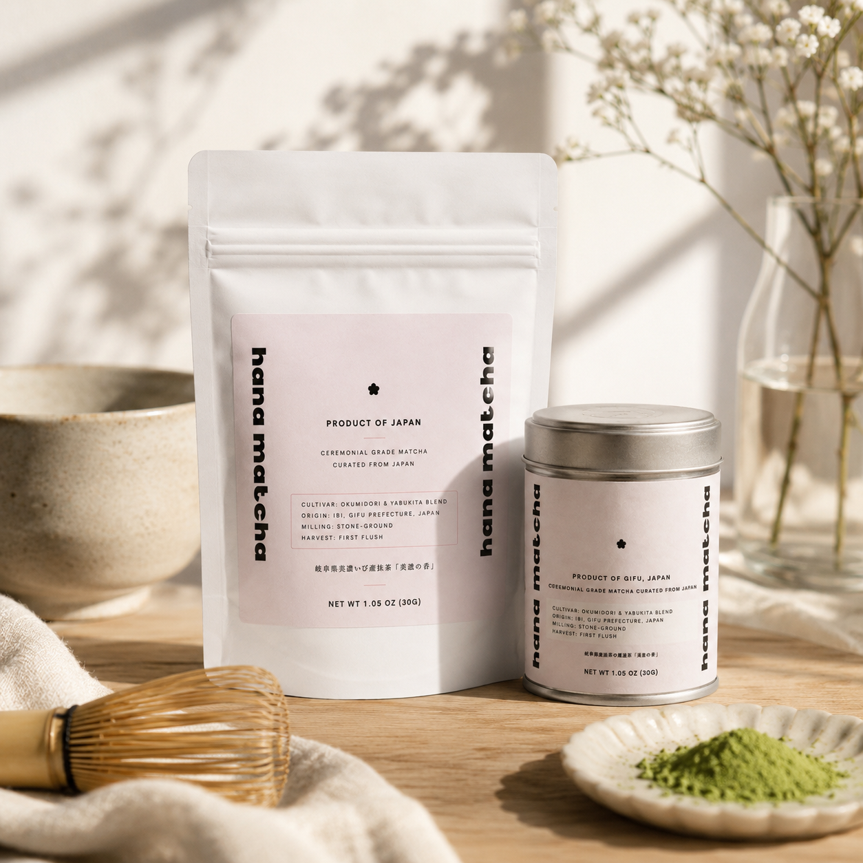 Hana Matcha pouch and tin styled with a bamboo whisk, ceramic bowl and dried flowers in soft daylight